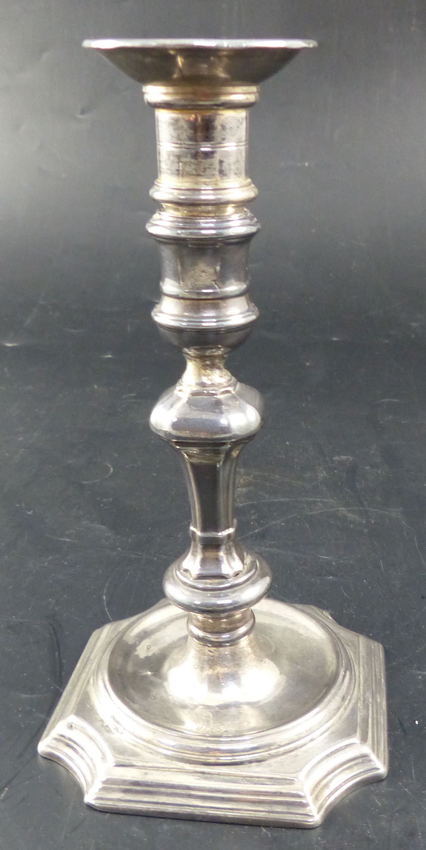 A George II cast silver candlestick by Abraham Buteux, London, circa, 1725, 14.7cm, 11oz.